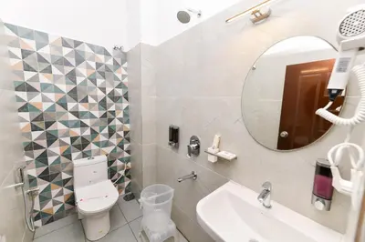 a bathroom with a sink and a mirror at Hotel Shine International in Mysore