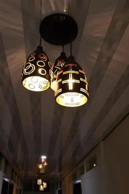 two lights hanging from a ceiling in a room at TAJ Residency in Mannārakkāt