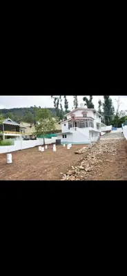 a large house with a pool in front of it at Attuvam Valley in Kodaikānāl