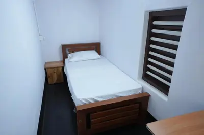 a small bedroom with a bed and a window at Koodapuzha House Chalakudy in Kizhake Chālakudi