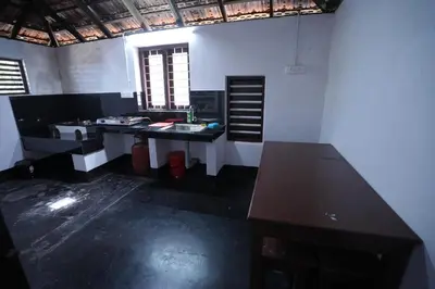 a kitchen with a counter top in a room at Koodapuzha House Chalakudy in Kizhake Chālakudi