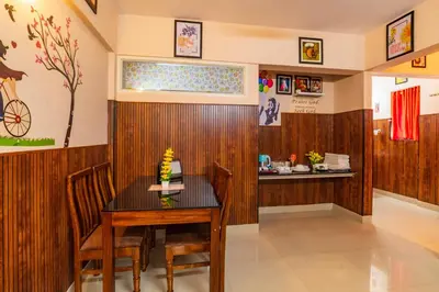 a dining room with a table and chairs at Sancta Maria Airport Suites in Nedumbassery