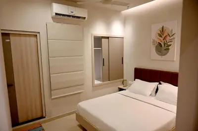 a small bedroom with a bed and a mirror at K.K RESIDENCY in Palakkad