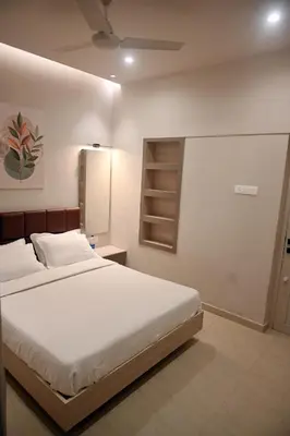 a bedroom with a large white bed in a room at K.K RESIDENCY in Palakkad