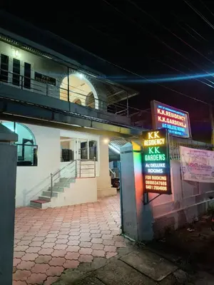 a building with a sign in front of it at night at K.K RESIDENCY in Palakkad
