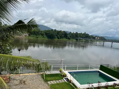a large body of water with a swimming pool at River View Apartments a Pet Friendly Retreat in Ernakulam
