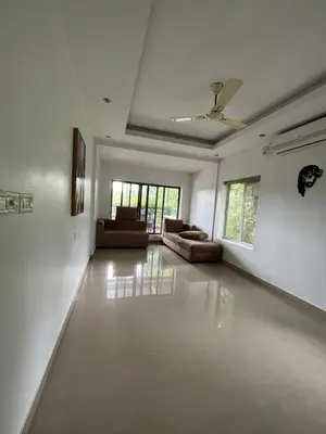 a large living room with couches and a ceiling at River View Apartments a Pet Friendly Retreat in Ernakulam
