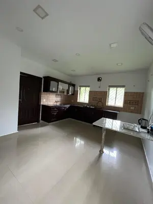 an empty room with a table in the middle at River View Apartments a Pet Friendly Retreat in Ernakulam