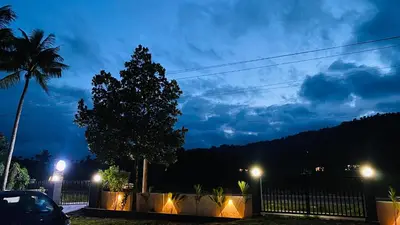 a car parked in a parking lot at night at Captain's Cove Home Stay in Sultan Bathery
