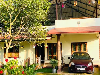 a car parked in front of a house at Captain's Cove Home Stay in Sultan Bathery