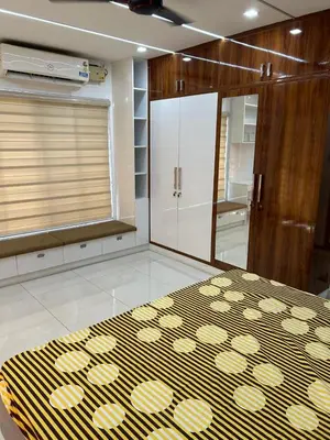 a room with a rug on the floor and a mirror at Thottan house in Trichūr