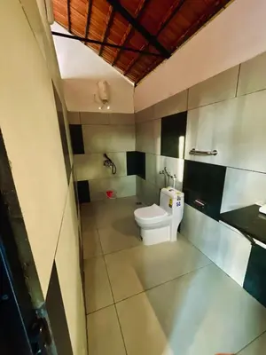 a bathroom with a toilet in a room at Josh Holidays Wayanad in Vaduvanchal