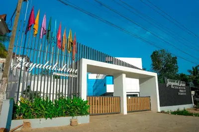 a row of flags in front of a building at Jayalakshmi Residency in Vaduvanchal