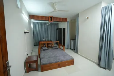 a bedroom with a bed and a table in it at A4, Melam, Hima Havens- 200 m from Guruvayoor Temple in Guruvāyūr