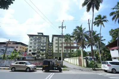 a golf cart parked on a street with buildings at A4, Melam, Hima Havens- 200 m from Guruvayoor Temple in Guruvāyūr