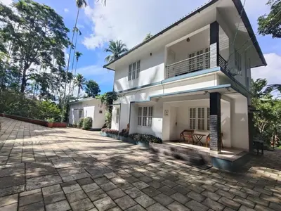 a house with a courtyard in front of it at Exuberance Villa in Batheri