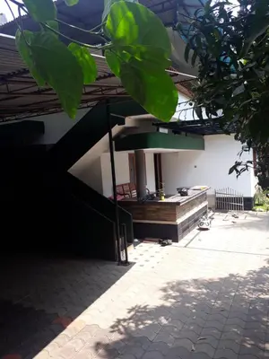 a house with a staircase leading to a patio at NIT Calicut Apartment in Tāzhekkod