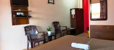 a room with a table and chairs and a table and a table and a table at Holidayincoorg - Brick lane in Madikeri