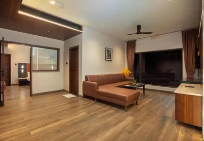 a living room with a couch and a tv at Apple Inn in Pollāchi