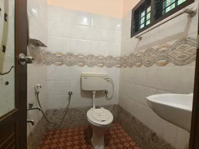 a bathroom with a toilet and a sink at Nirmalyam Homestay in Kuttippuram