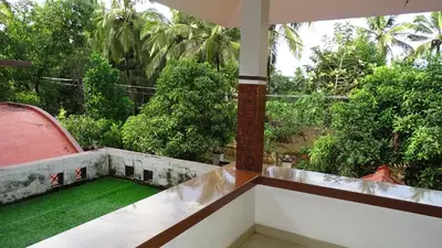 a balcony with a view of a garden at Nirmalyam Homestay in Kuttippuram