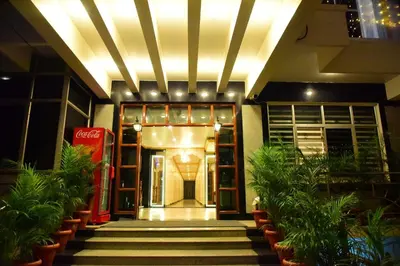 an entrance to a building with stairs and plants at Rajalakshmi Comforts Mysuru in Mysore
