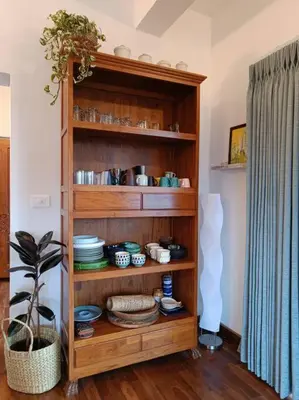 a wooden book shelf with dishes on it at Shangrila Casa-Premium Homestay in Wellington Town