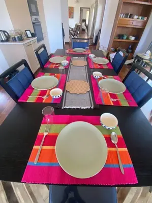 a long table with plates and chopsticks on it at Shangrila Casa-Premium Homestay in Wellington Town
