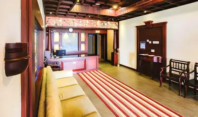 a living room with a couch and a window at Seaflare Beach Resort & Spa in Pallipuram