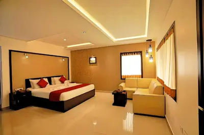a hotel room with a bed and a couch at Seaflare Beach Resort & Spa in Pallipuram