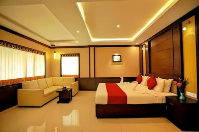 a hotel room with a bed and a couch at Seaflare Beach Resort & Spa in Pallipuram