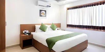 a bedroom with a large bed and a window at Seaflare Beach Resort & Spa in Pallipuram