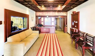 a living room with a couch and a striped rug at Seaflare Beach Resort & Spa in Pallipuram