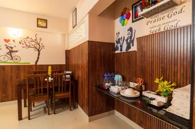 a restaurant with a table and a dining room at Mayflower Airport Launge cochin international airport in Nedumbassery