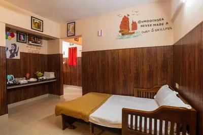 a bedroom with a bed with a sign on the wall at Mayflower Airport Launge cochin international airport in Nedumbassery