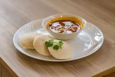 a plate with biscuits and a bowl of soup at Mayflower Airport Launge cochin international airport in Nedumbassery