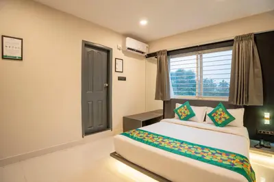a bedroom with a large bed and a window at Treebo Sanmaya Retreat, 15 Mins From Mysore Palace in Mysore
