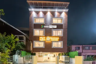 a building with a sign on the side of it at Treebo Sanmaya Retreat, 15 Mins From Mysore Palace in Mysore
