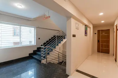 a staircase in a building with a window at Treebo Sanmaya Retreat, 15 Mins From Mysore Palace in Mysore