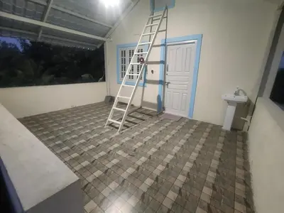 a bathroom with a ladder in front of a door at Suggi Farm House in Halgūr