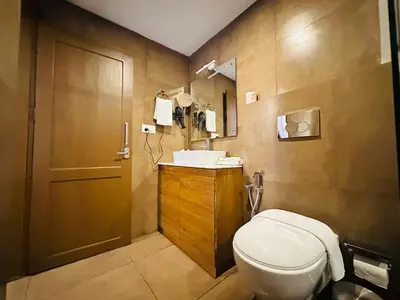 a bathroom with a toilet and a sink at City Palace Residency Nilambur in Wandūr