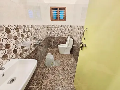 a bathroom with a sink and a toilet at Bricknest hillview in Mysore