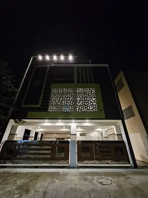a building with lights on top of it at night at Bricknest hillview in Mysore