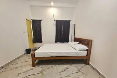 a bedroom with a bed in a room at Bricknest hillview in Mysore