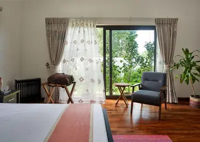 a living room with a chair and a window at Shangrila Casa-Premium Homestay in Lovedale