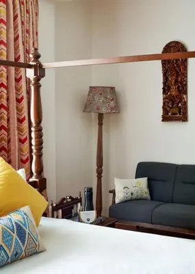 a living room with a couch and a lamp at Shangrila Casa-Premium Homestay in Lovedale