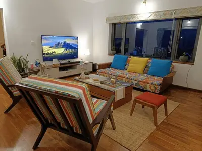 a living room with a couch and a tv at Shangrila Casa-Premium Homestay in Lovedale
