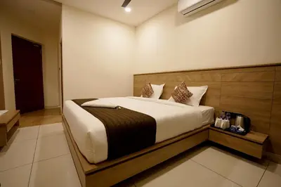 a bedroom with a large bed in a room at Stayon Hotels in Palakkad