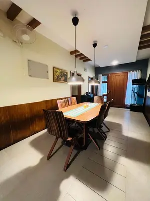 a dining room with a table and chairs at Yemcee Rivera in Tellicherry