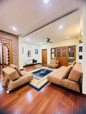 a large living room with two couches and a rug at Yemcee Rivera in Tellicherry